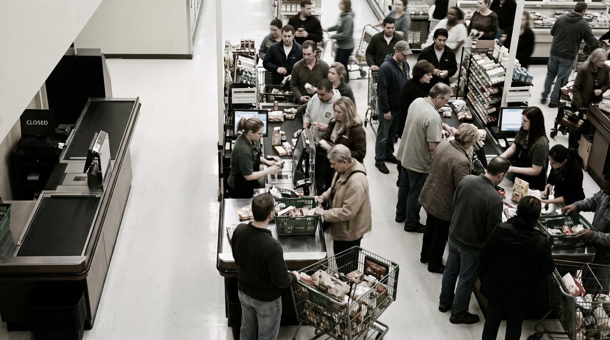 A busy checkout with one closed register