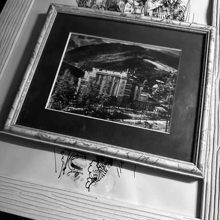 A framed photograph of the hotel, found in the house