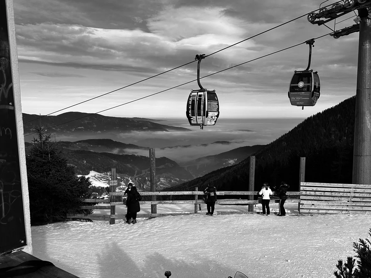 Gondolas above a sea of clouds at the top station