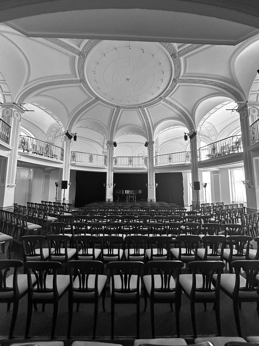 Rows of chairs under the domed ceiling of the Panhans ballroom