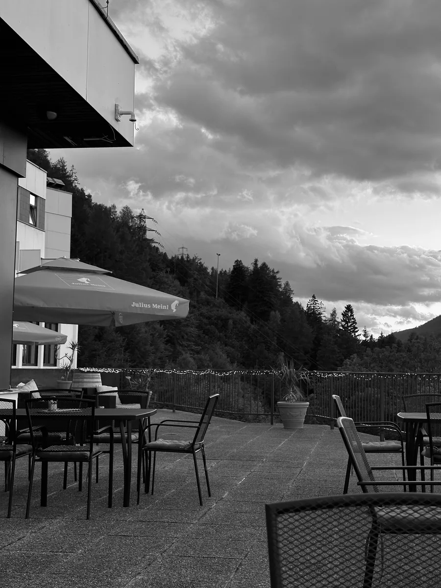 The hotel terrace at sunset, dramatic clouds over the valley